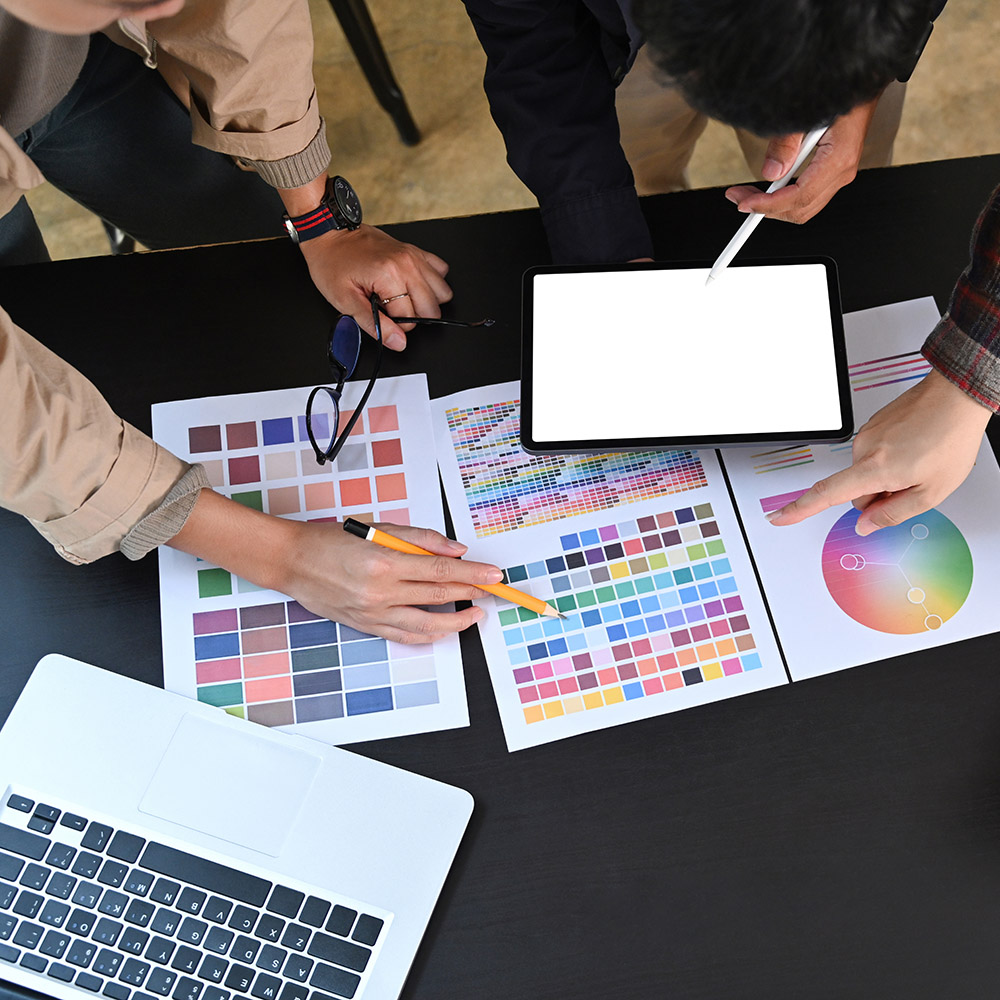 Overhead view group of young graphic designer working with color
